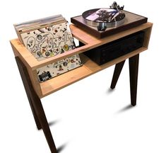 an old record player and turntable on a wooden table with vinyl records in it