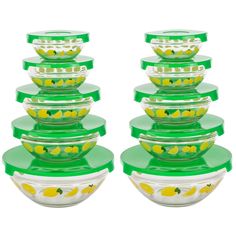 a stack of glass bowls with lemons painted on the lids and bottom, all stacked together