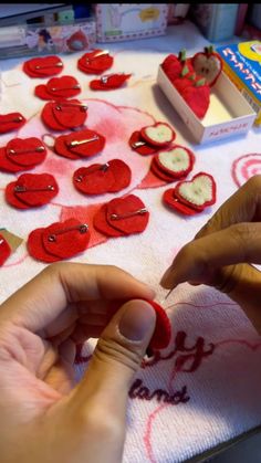 someone making valentine's day hearts out of felt