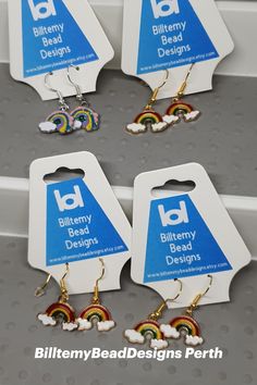 four pairs of earrings with different designs on them