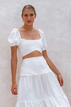 The beautiful 'Blanca' crop top is handcrafted from high quality breathable crinkle linen. Designed with smocked back and stunning fold detailing at the front. Blanca linen top is meant to be worn with the coordinating 'Casablanca' skirt but can easily be styled with your favorite denim or neutral tailoring. Style Blanca crop top with Casablanca Maxi skirt. Features: -Content: 100% Linen-Hand wash cold-Shirred back-Elasticated sleeves-Slip on cropped style-Unlined-This style fits true to size. W Spring Beach Crop Top With Square Neck, Chic Crop Top With Smocked Bodice For Vacation, Chic Square Neck Crop Top For Beach, Chic Smocked Bodice Crop Top For Vacation, Chic Cropped Top With Smocked Bodice, Chic Smocked Bodice Crop Top, White Fitted Crop Top With Smocked Bodice, Chic Linen Crop Top For Vacation, Square Neck Crop Top For Spring Vacation