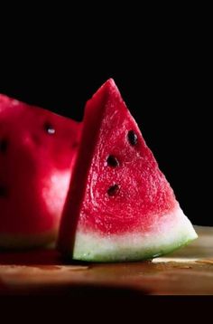 two slices of watermelon on a cutting board