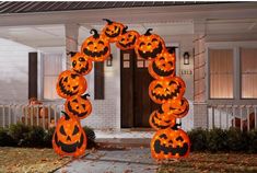 an outdoor halloween decoration with pumpkins on it