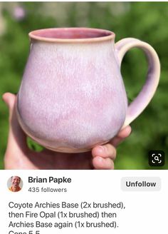 someone is holding up a pink coffee mug in front of their twitter account for the article