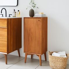 a wooden cabinet next to a sink in a bathroom