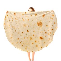 a woman holding up a large tortilla wrap