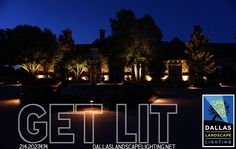 the words get lit are displayed in front of a large house with lights on it