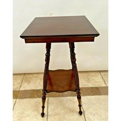 a small wooden table with one drawer on the top and two legs at the bottom