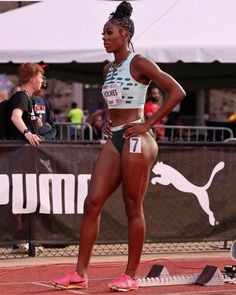 a woman standing on top of a race track