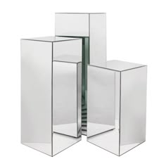 three mirrored cubes stacked on top of each other