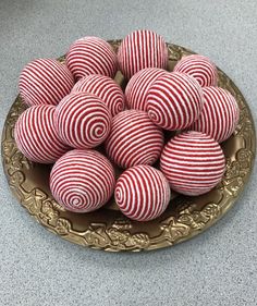 red and white striped balls on a gold plate