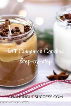 two jars filled with cinnamon candles on top of a table