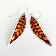 Ruby Red and GOLD Laurel Leaf Earrings – Cloisonné and Champlevé Enamels on Fine Silver 24k Gold Wires w Sterling Ear Wires by Sandra McEwenMaterials: Champlevé & cloisonné Enamels on Fine silver.EarringsSize: 2” long x .5” wideDid you know that enamels are melted glass?  Yes!  It's true...  To create this lovely pair of earrings, I first fabricated the silver base out of sheets of fine silver.  The lines of the design are actually fine silver wires that I meticulously bent by hand (and twee Red Polished Earrings For Gift, Traditional Polished Earrings As Gift, Traditional Polished Earrings For Gift, Red Hand Painted Sterling Silver Jewelry, Elegant Red Hand Painted Jewelry, Gold Hand-painted Teardrop Earrings, Gold Teardrop Earrings Hand Painted, Gold Hand Painted Teardrop Earrings, Elegant Inlay Earrings As Gift