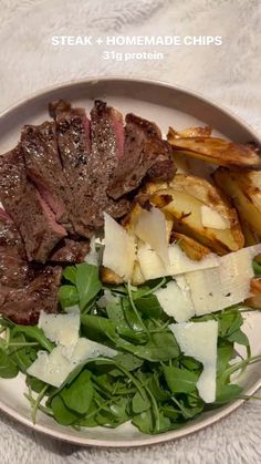 steak and homemade chips on a plate with greens