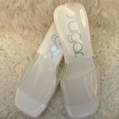 Clear Sandal Strap With White Heel. White Trendy Slip-on Jelly Sandals, White Closed Toe Jelly Sandals For Summer, Clear Block Heel Jelly Sandals, Clear Jelly Sandals With Block Heel, Clear Open Heel Jelly Sandals For Summer, Summer Clear Jelly Sandals With Open Heel, Clear Closed Toe Jelly Sandals For Spring, Trendy Clear Sandals For Summer, Spring Clear Closed Toe Jelly Sandals