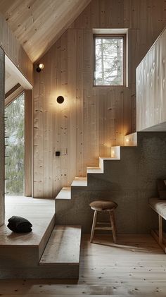 the interior of a house with wooden walls and stairs