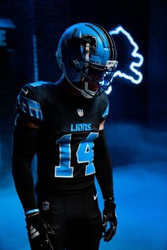 a football player wearing a black uniform and blue helmet