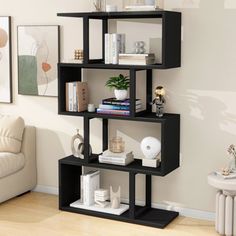 a black book shelf with books on it in a living room