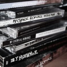 a stack of cds sitting on top of a wooden table