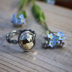 This collection of stacking rings focuses on vibrant colour, shine and intricately detailed stones. Blackened silver settings, polished to a beautiful but understated shine, the settings vary in style and detail but share the unique charm of a layered patina and antiqued aesthetic.  This ring features a favourite, faceted pyrite. An oval shaped stone set in a plan bezel with a handmade twisted and hammered shank, this design is a perfect juxtaposition of practicality and ornamentalism. Stone hei Antique Aesthetic, Stacking Ring, Unique Charms, Stone Settings, Stacking Rings, Rings Statement, Wedding Shop, Mother Nature, Statement Rings