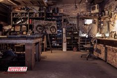 a man is standing in the middle of a workshop with lots of work on it