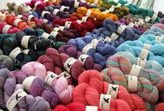 many skeins of yarn are on display for sale