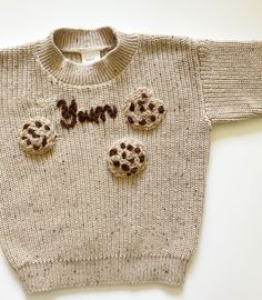 Cute Cookie hand embroidered knit sweatshirt. This sweatshirt features hand embroidered cookies & 'Yum' stitching, adding a playful twist to  an everyday essential.  This sweatshirt comes in soft & light cotton blend knit material, making it ideal for all year round.  The speckled oatmeal colour makes this sweatshirt versitile and able to be styled with any outfit!  Available in 6-12M, 12-18M, 2-3Y & 3-4Y Cozy Cotton Hand Knitted Sweater, Cozy Cotton Hand-knitted Sweater, Cozy Hand-knitted Cotton Sweater, Cozy Hand Knitted Cotton Sweater, Cream Cotton Crochet Sweater, Beige Crochet Cotton Sweater, Cream Crochet Cotton Sweater, Playful Knitted Cotton Tops, Cute Cream Cotton Sweater