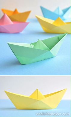 three different colored paper boats sitting on top of each other