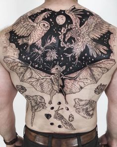 the back of a man with tattoos on his body and wings flying above him, surrounded by other animals