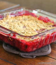 a casserole dish filled with fruit on top of a wooden table