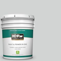 the behr paint and primer in one is shown on a gray background with red trim