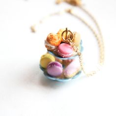 This gorgeous necklace features a miniature tiered metal pendant adorned with handmade french pastries made from polymer clay. The pastry assortment includes french macarons, cream puff, chocolate croissant, strawberry eclair, strawberry tart and, strawberry mousse. The pendant measures 3 cm tall and is securely attached to a gold tone chain necklace that measures 24 inches in length. Eclair Strawberry, Cream Puff Chocolate, Croissant Strawberry, Strawberry Eclair, Strawberry Tart, Strawberry Mousse, French Macaron, Stylish School Bags, Miniature Food Jewelry