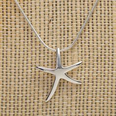 This necklace is perfect for everyday wear and would make a great gift for the beach lover in your life.Both the starfish and chain are sterling silver.The starfish pendant measures 19mm x 22mm (0.75" x 0.85").Includes an 18" snake chain. Sterling Silver Starfish Charm Pendant Necklace, Sterling Silver Starfish Charm Necklace, Sterling Silver Necklace With Starfish Charm, Sterling Silver Pendant Necklace With Starfish Charm, Sterling Silver Starfish Necklace With Star Charm, Sterling Silver Starfish Charm Jewelry, Maine Gifts, Starfish Pendant, Starfish Necklace