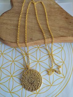 "Stunning large Gold Phaistos disk pendant with quality gold 30\" chain This pendant can become a fascinating focal point of conversation and will look stunning in Summer or Winter.  The original Phaistos Disc is on display at the archaeological museum of Heraklion. It is a disk of fired clay from the Minoan palace of Phaistos on the island of Crete, dating to the middle or late Minoan Bronze Age (which is the second millennium BC). The disk is about 15 cm diameter and is covered on both sides with a spiral of stamped symbols. Its purpose and its original place of manufacture are a mystery but it is fascinating and stunning to look at in all its detail.  The Phaistos Disc captured with its images pressed into clay concentrically, fires the imagination of amateur and professional archaeolog Ancient Greek Jewelry, Greek Jewelry, Leather Chokers, Ancient Mysteries, Ancient Coins, Disc Pendant, Bronze Age, Gift For Music Lover, Green Earrings