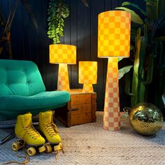 two yellow roller skates sitting next to a green chair