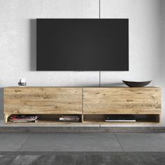 an entertainment center with a flat screen tv mounted on the wall