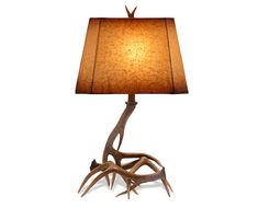 an antler lamp with a brown shade on the base and a light bulb attached to it