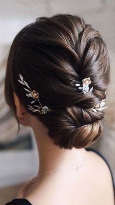 a woman wearing a hair comb with flowers on it's head and braid in her hair