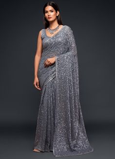 Dominate any party or event with this premium grey sequins and thread designer saree. Made with luxurious georgette fabric, it will make you stand out from the crowd. Perfect for receptions and festive occasions, it also makes a great gift for your girlfriend. Take on the challenge and embrace the adventure of looking stunning and confident! The unstitched blouse can be customized upto 42 inches. Do Note: All the accessories shown are for styling purpose only. Slight color variation may occur du Sequins Saree, Sequence Saree, Grey Saree, Sequin Saree, Party Sarees, Party Wear Saree, Red Lehenga, Patiala Salwar, Party Kleidung