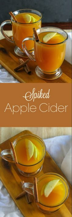 two glasses filled with apple cider on top of a wooden tray