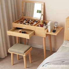 a wooden vanity table with drawers and stools