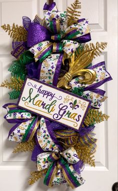 a happy mardi gras wreath on the front door with purple and green ribbons