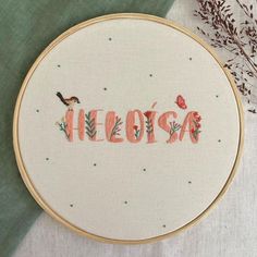 a cross stitch pattern with the word fiesta written in cursive font surrounded by flowers