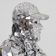 a man made out of mirrors with a baseball cap on top of his head and one eye closed