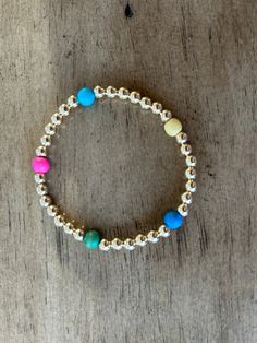 Add a touch of whimsy to your outfit with the Paintbox Spring Angela Bracelet. This unique piece features a combination of gold filled and wood, providing a modern and natural look. Perfect for any occasion, this bracelet is sure to make a playful statement. 6mm colored wood beads and 5mm gold filled beads We mix aqua, turquoise, yellow, pink and green HOC-Spring 000085 000089 000086 000082 000080 Paintbox Spring, Hoc Spring, Spring Mix, Aqua Turquoise, Natural Look, Wood Beads, Pink And Green, Unique Pieces, Gold Filled