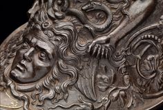 a close up of a metal object with an image of a man's face on it