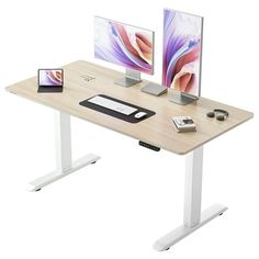 two computer monitors sitting on top of a wooden desk