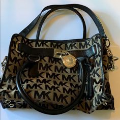 Vintage Michael Kors Mk Handbag Medium Size Lock And Key Style Worn But Has A Lot More Use To It Good Condition Comes With Mk Storage Bag Michael Kors Black Shoulder Bag With Leather Handles, Michael Kors Leather Handle Shoulder Satchel, Michael Kors Shoulder Satchel With Leather Handles, Michael Kors Shoulder Bag With Branded Hardware For On-the-go, Michael Kors Black Bag With Leather Handles, Michael Kors Satchel With Branded Hardware For Daily Use, Michael Kors Leather Satchel For Everyday Use, Michael Kors Satchel With Branded Hardware, Michael Kors Travel Shoulder Bag With Detachable Handle