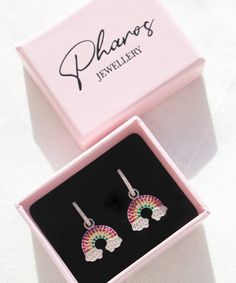 Rainbow and Clouds Earrings These cute rainbow and clouds earrings will definitely brighten up your mood on a rainy day! Their gorgeous colors will add a precious touch to your daily outfits and bring you compliments here and there. They are also a perfect gift for your loved ones as they are presented in a beautiful pink gift box. But, you can always spoil yourself too! Features: * These earrings are sold in pairs. * They are made of 925 Sterling Silver Packaging: You will get your jewelry in a Rainbow Drop Earrings As A Gift, Rainbow Hypoallergenic Earrings As Gift, Hypoallergenic Rainbow Hoop Earrings As Gift, Rainbow Crystal Drop Earrings For Gift, Rainbow Hoop Earrings With Ear Wire For Gift, Rainbow Hoop Earrings With Ear Wire As Gift, Multicolor Cubic Zirconia Crystal Earrings Gift, Rainbow Drop Earrings For Pierced Ears, Trendy Multicolor Crystal Earrings As Gift