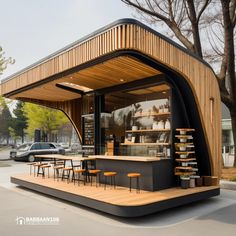 an outdoor cafe with tables and stools on the side of the road in front of some trees